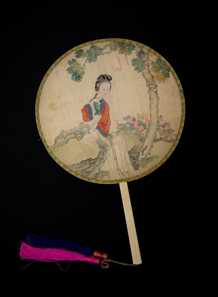 PADDLE FAN WITH WOMAN READING IN A LANDSCAPE